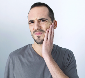 man holding jaw in pain